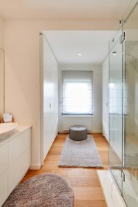 a bathroom with a sink and a glass shower at CityStudios in Luxembourg +24 photos