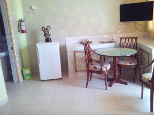 a kitchen with a table and chairs and a refrigerator at Amigos Beach Resort in Boracay