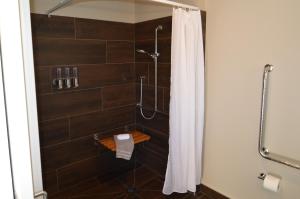 a bathroom with a shower with a shower curtain at BeachBox Boutique Accommodation in Coopers Beach
