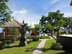 a garden with a gazebo and a path at Samari Hill Villa in Buleleng