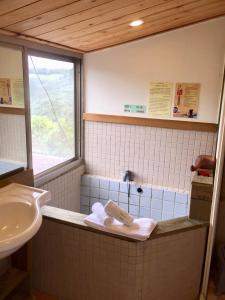 a bathroom with a sink and a bath tub at New Life Hot Spring Resort in Yuli +32 photos
