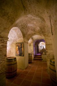a wine tasting room with barrels and a staircase at Hotel Spa La Casa Del Convento in Chinchón