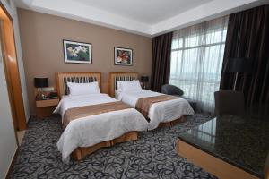 Postel nebo postele na pokoji v ubytování Tenera Hotel