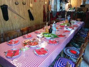 a long table with a red and white checkered table cloth at Rajacke pivnice Country House C`est La Vie in Rajac