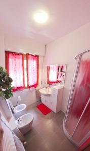a bathroom with a toilet a sink and a bath tub at La Terrazza in Empoli