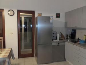 a kitchen with a stainless steel refrigerator at Cres in Cres