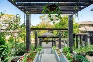 a garden with a pergola with plants at The Mountain Courtyard Thekkady in Thekkady