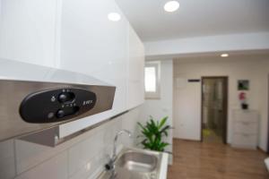 a kitchen with a sink and a counter top at Apartments MTV with privatne parking in Zadar
