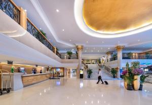 a person walks through the lobby of a shopping mall at Novotel Beijing Peace in Beijing