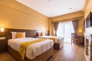 Letto o letti in una camera di Hotel Mala Pokhara