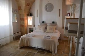 מיטה או מיטות בחדר ב-Masseria Curice