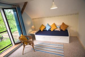 a bedroom with a bed with yellow and blue pillows at Bořetínský Statek in Bořetín