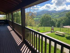 a porch of a cabin with a view of the mountains at BellasVistas in Beloncio