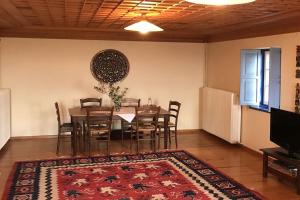 a dining room with a table and chairs at Chariklia Traditional House in Papingo
