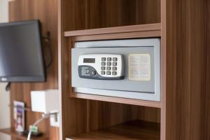 a microwave in a cabinet in a hotel room at Hotel Restaurant Resslirytti in Basel