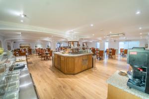 a kitchen and dining room with wooden tables and chairs at Atlantic Hotel in Tenby