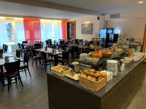 a buffet line in a restaurant with tables and chairs at Hotel Well Garni in Wittlich