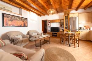 a living room with a couch and a table at Madalena's Summer House in Adamantas