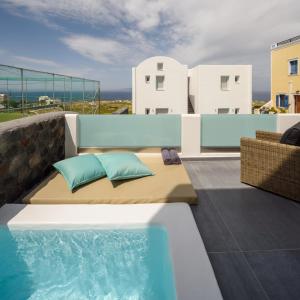 a rooftop patio with a couch and a swimming pool at Elitoz Suites in Oia
