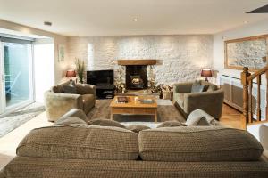 a living room with a couch and a fireplace at Stuc an t Sagairt Cottage , Loch Lomond in Drymen