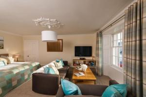 a living room with a bed and a couch at Thornhill House - Historic 5 Bedroom 5 Ensuite in Stirling