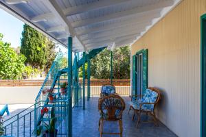 a porch with rocking chairs and awning at Agapanthus house in Lefkada
