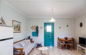 a living room with a blue door and a table at Agapanthus house in Lefkada