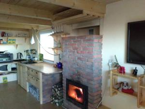 a brick fireplace in a kitchen with a fire place at Domek Panorama in Lipowa