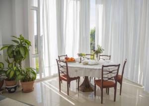 a dining room with a table and chairs and a window at Villa Alba in Preveza