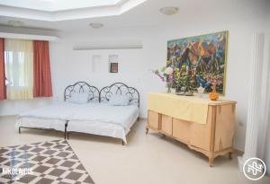 a bedroom with a bed and a table with flowers on it at Villa Alba in Preveza