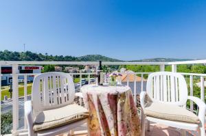 a table and two chairs on a balcony at Pansion Srebreno in Mlini