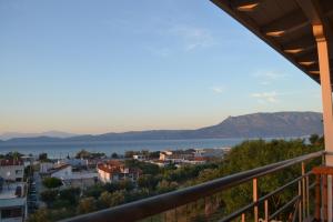 a view of the water from the balcony of a house at Corinthian Sun - Vacation Home in Korinthos