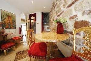 a room with a table with a vase of flowers on it at VG Three Bedroom Castle in Kotor