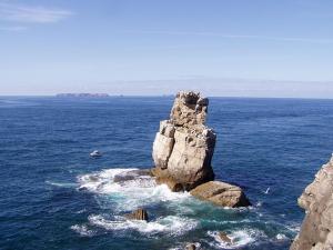 a rock formation in the middle of the ocean at Casa Moinho do Oeste - West Windmill Portugal in Moledo