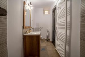 a bathroom with a sink and a mirror at Gloria Apartments in Sighişoara