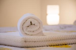 a rolled up towel sitting on a table at Apartmani Mirjana in Herceg-Novi