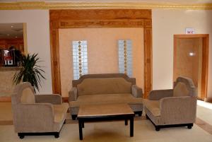 a waiting room with two chairs and a table at Hawaii Riviera Club Aqua Park - Families and Couples Only in Hurghada