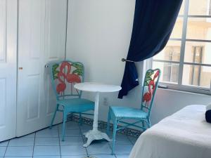 a room with two chairs and a table and a window at Beachfront Ocean Dr white sand paradise SoBe 311 in Miami Beach