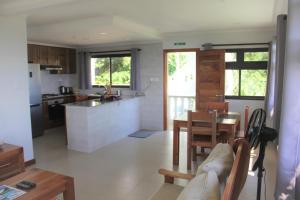 a kitchen and living room with a table and chairs at Island Cove in Victoria