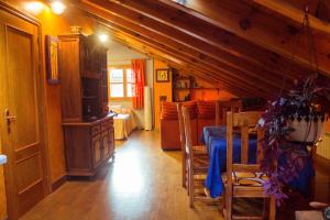 a dining room with a blue table and a kitchen at Casa rural Bal D'Onsella in Lobera de Onsella