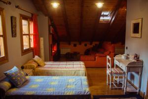 a room with two beds and a couch in it at Casa rural Bal D'Onsella in Lobera de Onsella