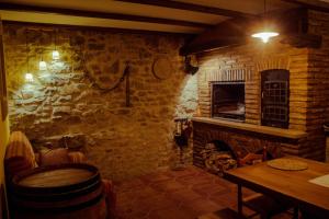 a stone room with a table and a fireplace at Casa rural Bal D'Onsella in Lobera de Onsella
