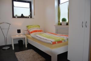 a bedroom with a bed and a window at Ferienwohnung Hedi in Mastershausen