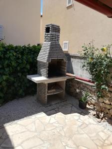 a brick oven sitting on a patio at Apartment Bonita in Vir