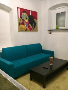 a blue couch in a living room with a table at City Center AP 2 in Košice