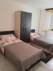 a bedroom with two beds and a cabinet at Apartment Bonita in Vir