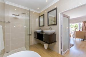 a bathroom with a sink and a shower at Villa Capri Guesthouse Ballito in Ballito