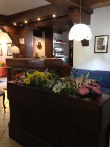 a table with a vase filled with flowers on top of it at Hotel Triolet in Courmayeur