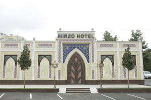 a large building with a sign on top of it at Mirzo Boutique Hotel in Tashkent