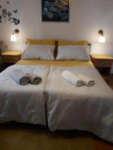 a bedroom with two beds with towels on them at Apartments Garden in Rovinj